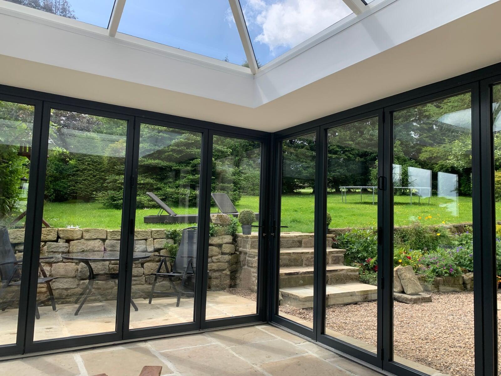 Corner bifold door system installed into an orangery
